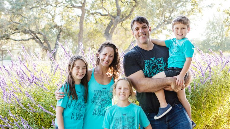 Kate Welbourn and family smiling wearing wade army shirt