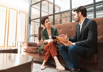Businessman consulting woman coworker