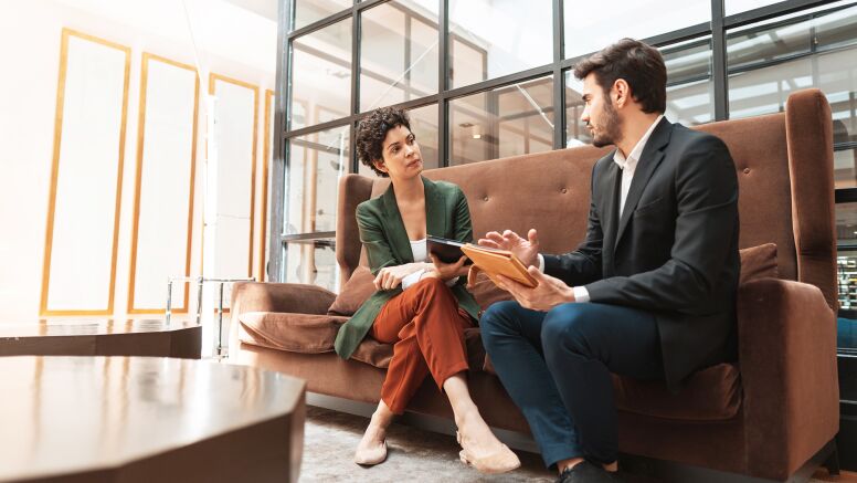 Businessman consulting woman coworker