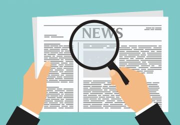 News Article and Magnifying Glass