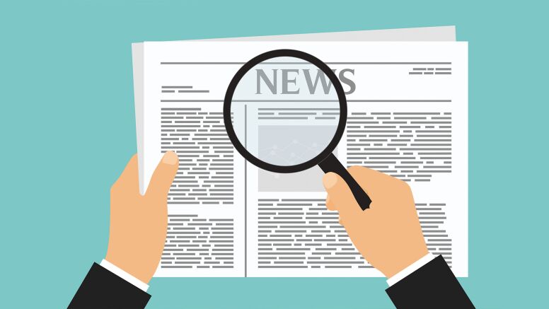 News Article and Magnifying Glass