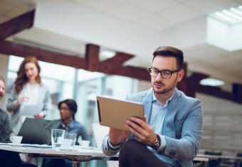 business person using tablet during meeting