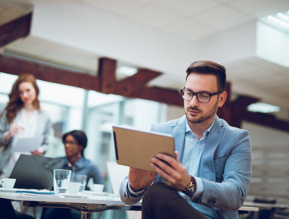 business person using tablet during meeting