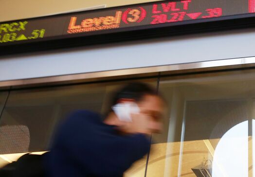 walking by stock ticker with phone