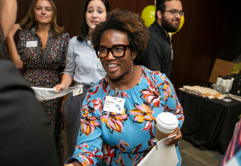 MAC student smiles while looking off camera at OLI