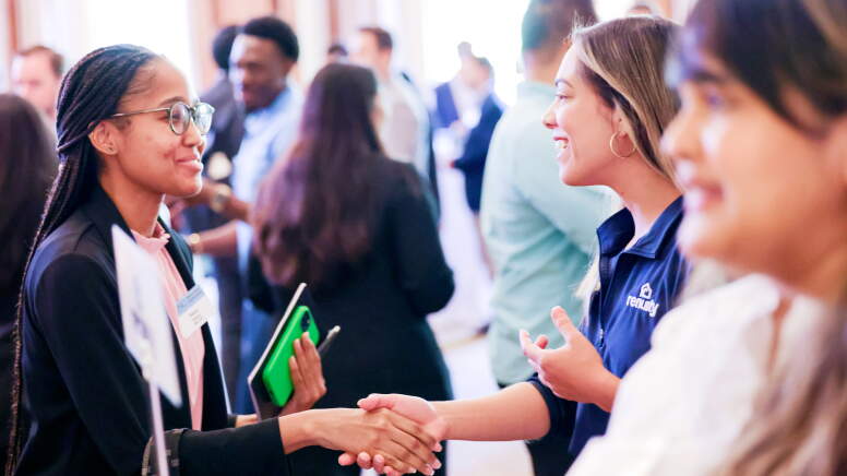 Student shaking hands with a recruiter