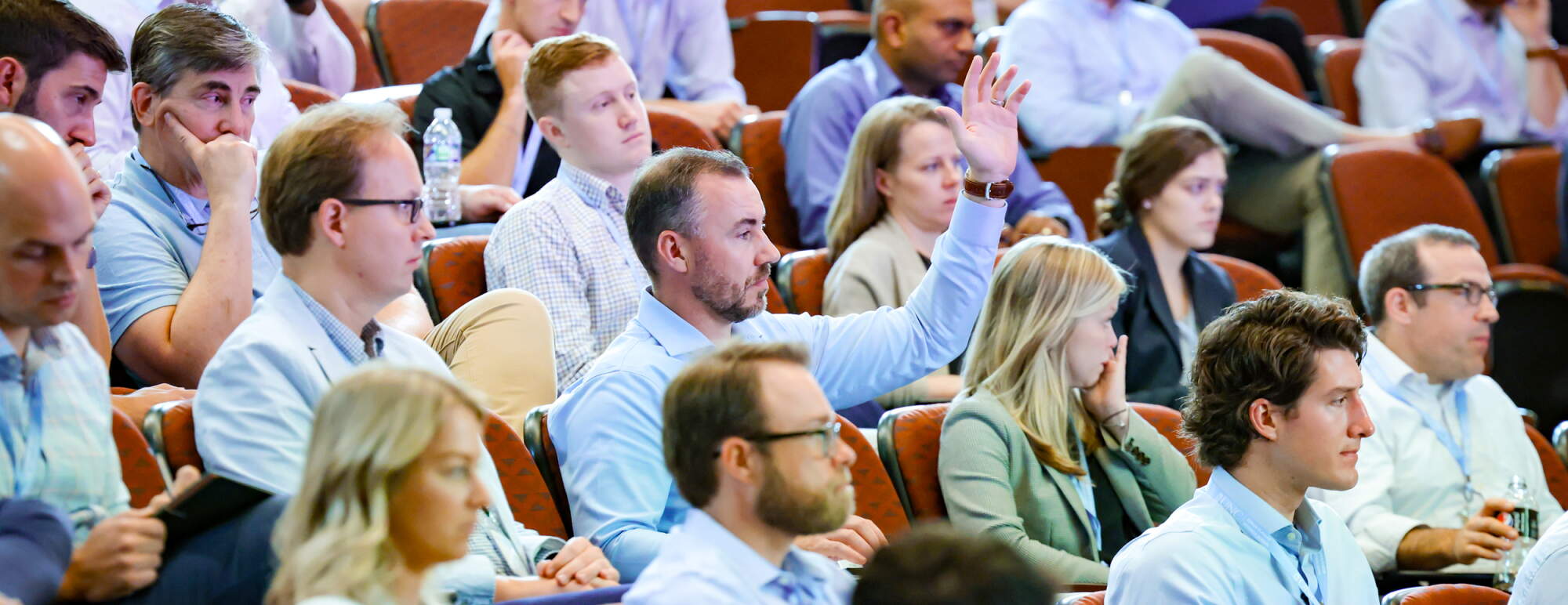 Student raising hand in a lecture