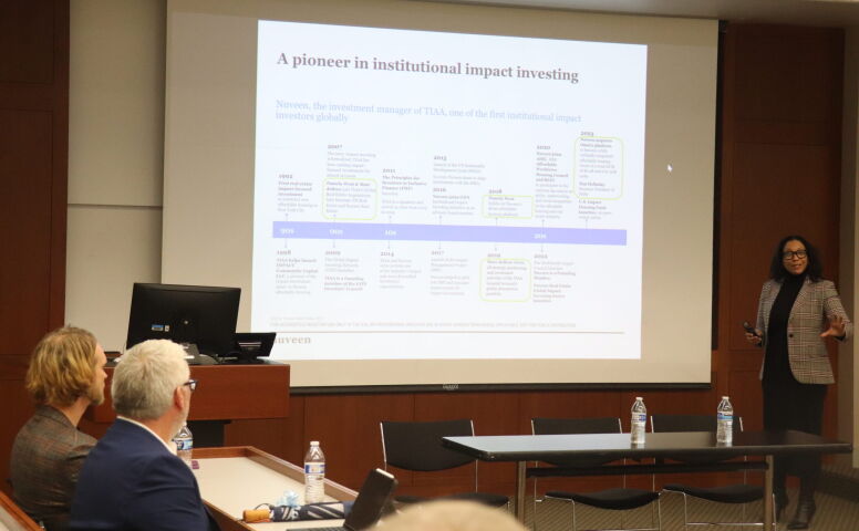 Pamela West presents slides to MBA and undergraduate students about the affordable housing portfolio purchased by Nuveen last year.