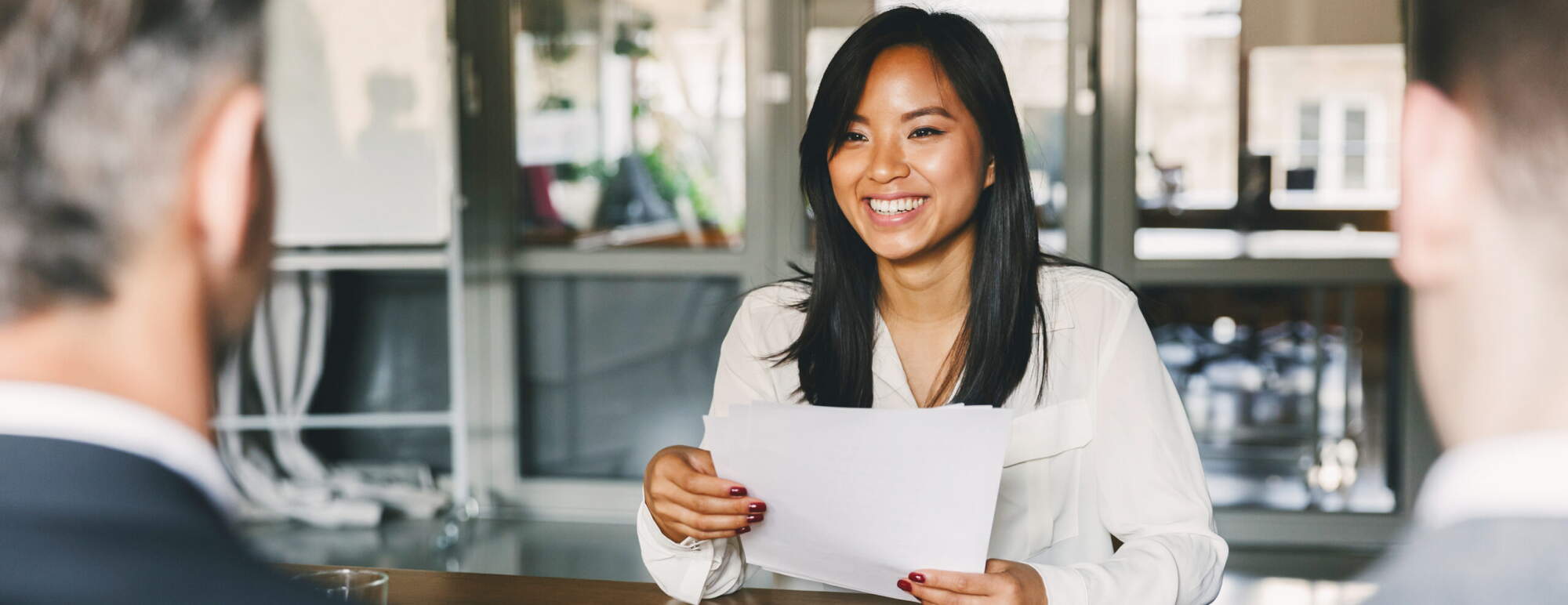 Woman holding her resume at a job interview
