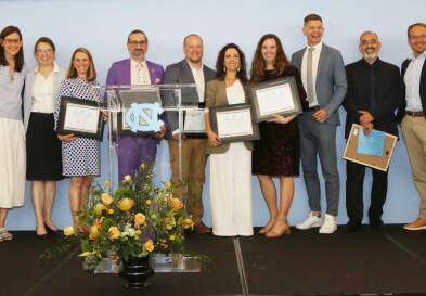 The winners show off their awards alongside Dean Mary Margaret Frank at the Blue Zone.