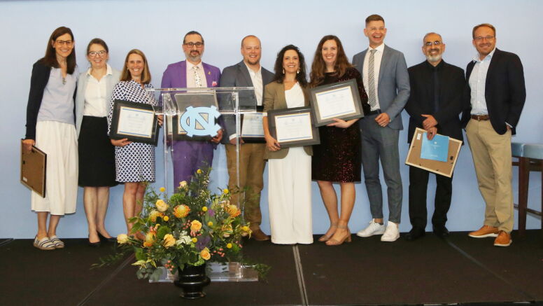 The winners show off their awards alongside Dean Mary Margaret Frank at the Blue Zone.