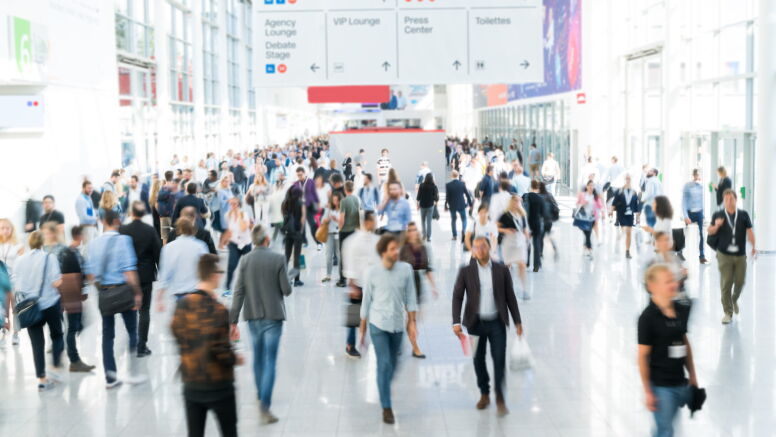 A blurred large crowd at an airport.