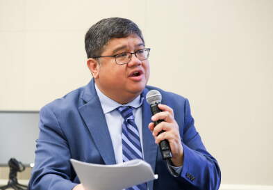 Eric Maribojoc with a microphone.