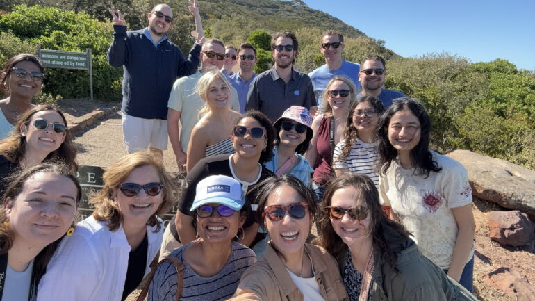 A big group of students smiling at the camera on a global trip in South Africa