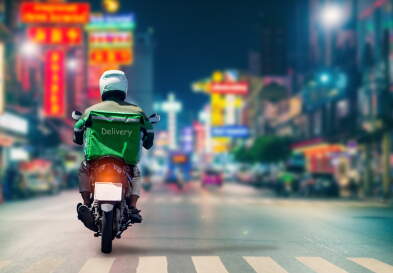 Delivery driver on a scooter to deliver food.