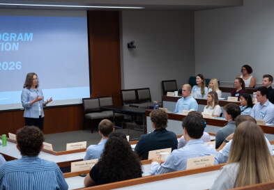 Dean Frank speaks to new Master of Science in Management students in a classroom during their orientation.