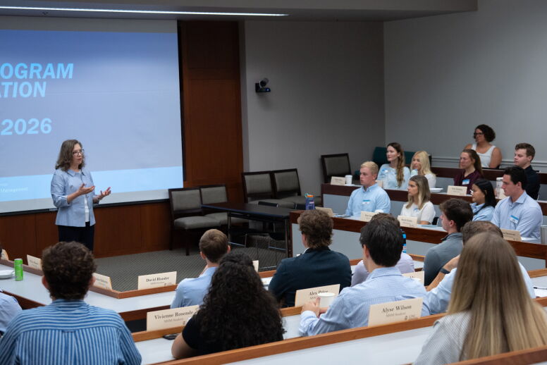 Dean Frank speaks to new Master of Science in Management students in a classroom during their orientation.