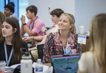 An attendee of the Tar Heel Business Academy smiles while in the classroom.