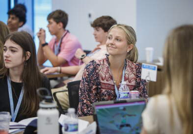 An attendee of the Tar Heel Business Academy smiles while in the classroom.