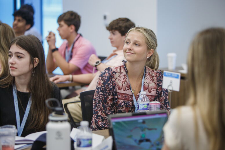 An attendee of the Tar Heel Business Academy smiles while in the classroom.