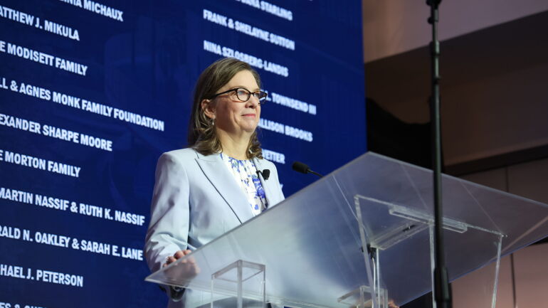 Dean Frank smiles at the podium.