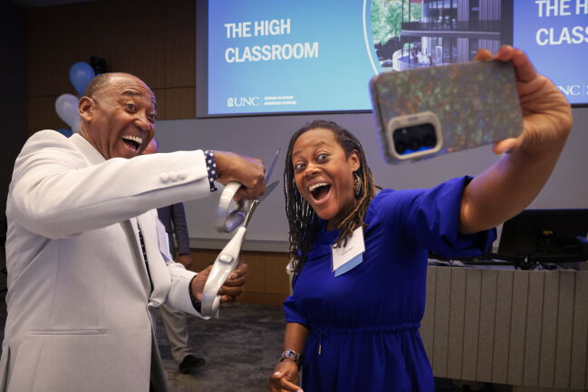 Joseph Cooley High jokes with giant scissors at the High Classroom dedication.