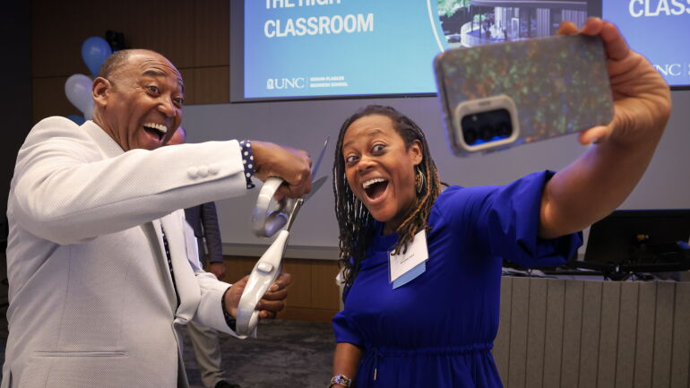 Joseph Cooley High jokes with giant scissors at the High Classroom dedication.