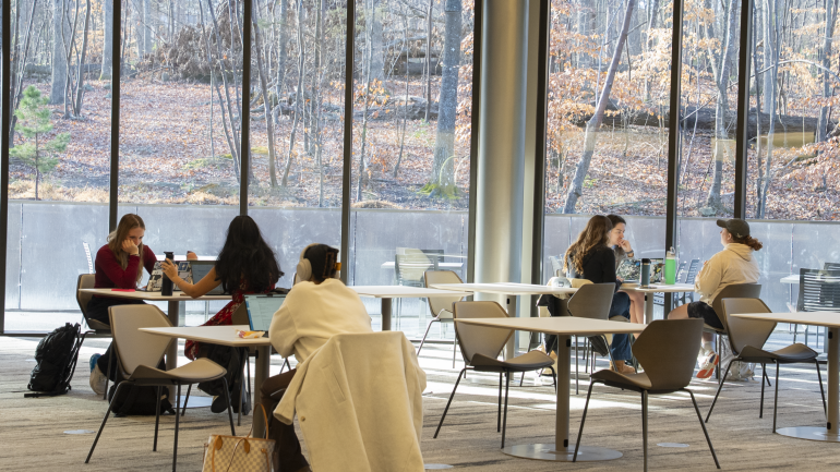 Students work in the dining area in Bell Hall.