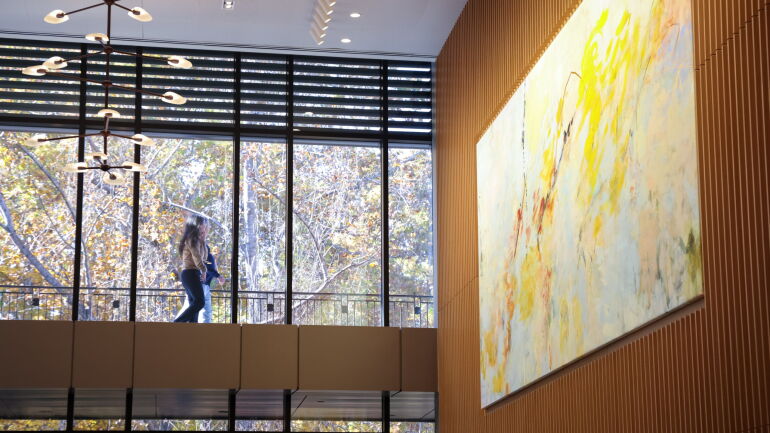 Megan Rooney’s “Stand Up Sky” hangs above the dining area in Bell Hall.