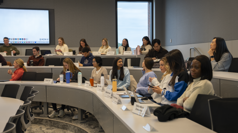 Students wait for class to begin in a Bell Hall classroom.