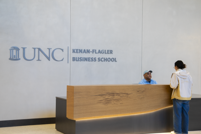 Front Desk Assistant Wayne Freeman chats with a student at the new front desk inside of Bell Hall.