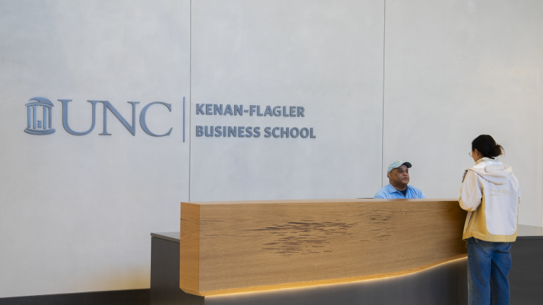 Front Desk Assistant Wayne Freeman chats with a student at the new front desk inside of Bell Hall.