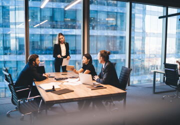 A group of colleagues working on a project together in boardroom.