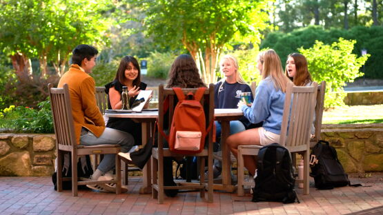 UNC Kenan-Flagler students studying outside in a class in Chapel Hill