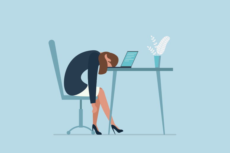 Cartoon of a tired worker with their head on their desk.