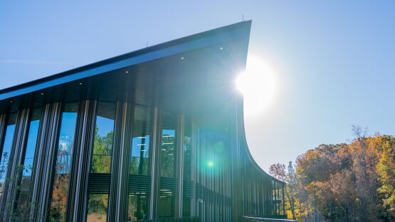Bell Hall is a modern building with a curved top and high windows.
