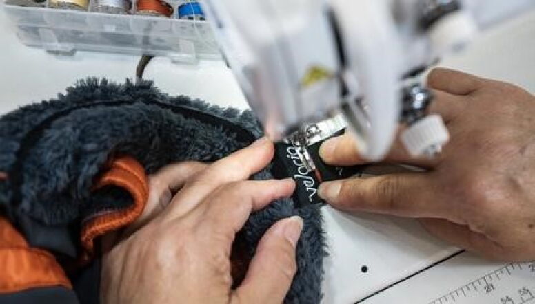 Hands working at sewing machine