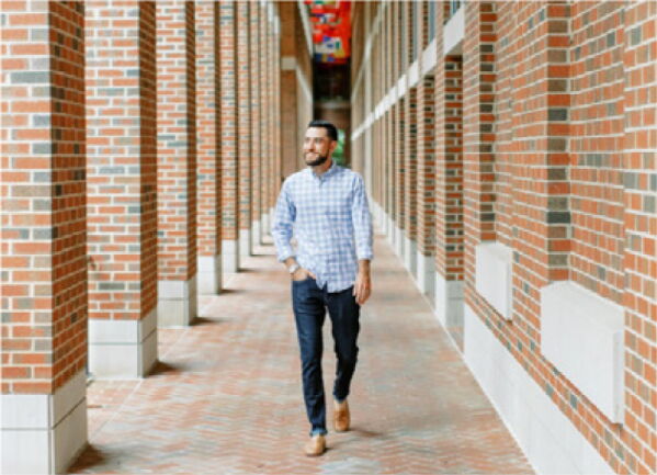 Student walking under flags