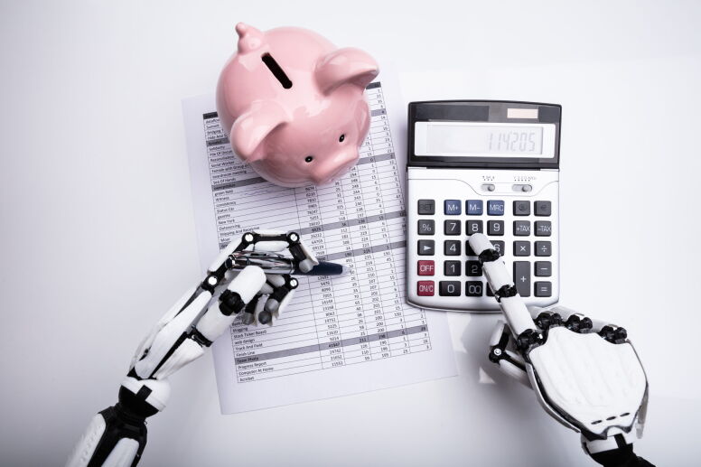 Close-up Of Robot Examining Financial Report With Calculator On Desk