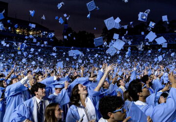 Carolina graduates throw their caps into the air at the spring 2026 commencement ceremony.