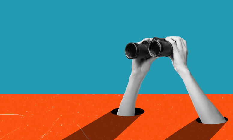 Hands holding binoculars on a blue/orange background