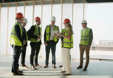 Real estate students in hard hats on a site