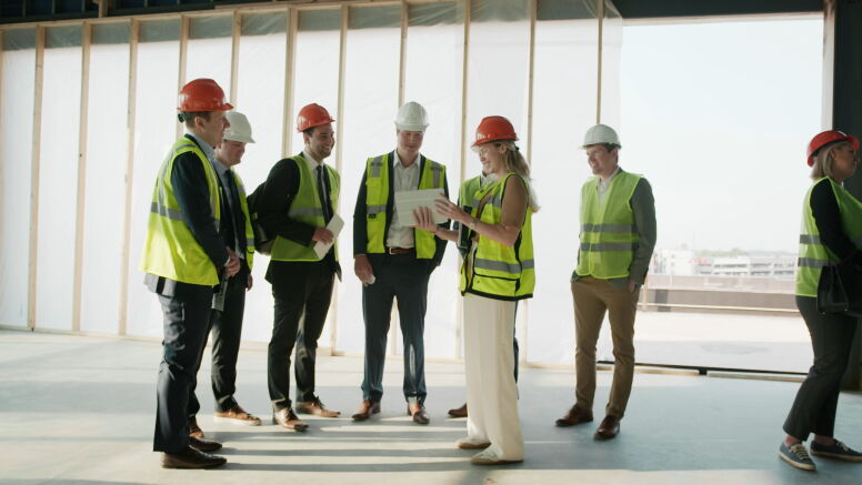 Real estate students in hard hats on a site